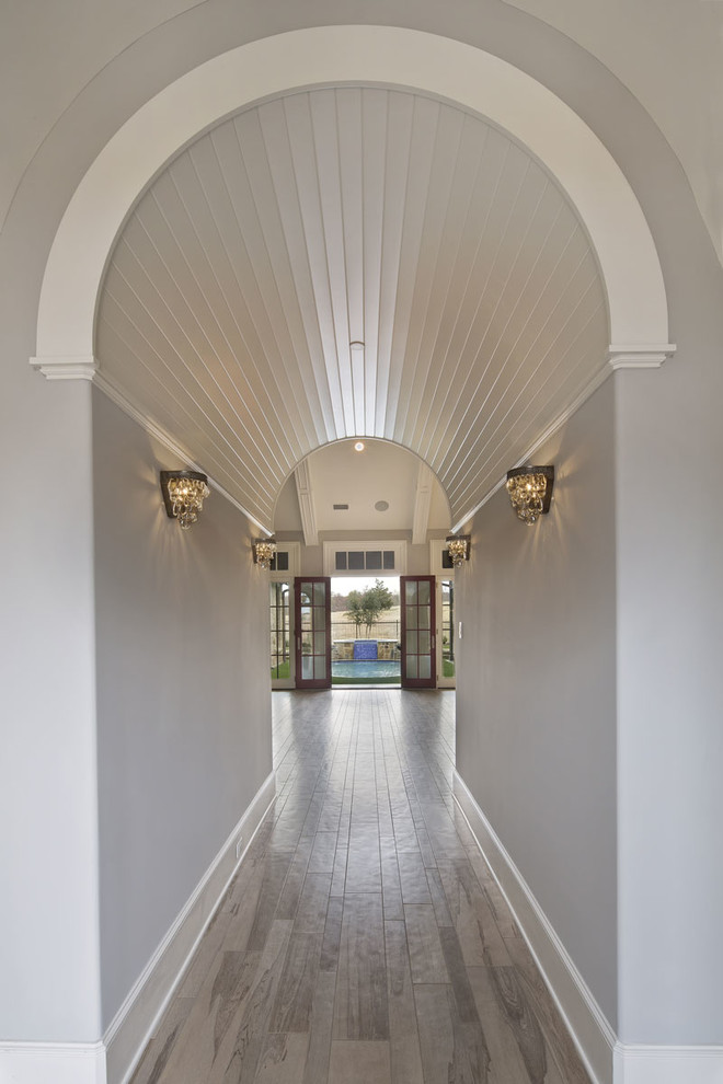 Inspiration for a large transitional light wood floor entry hall remodel in Dallas with white walls and a dark wood front door