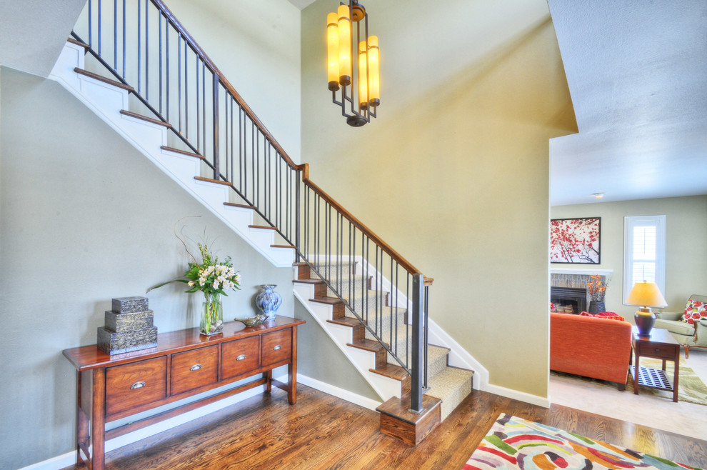 Inspiration for a large transitional medium tone wood floor foyer remodel in Denver with beige walls and a white front door