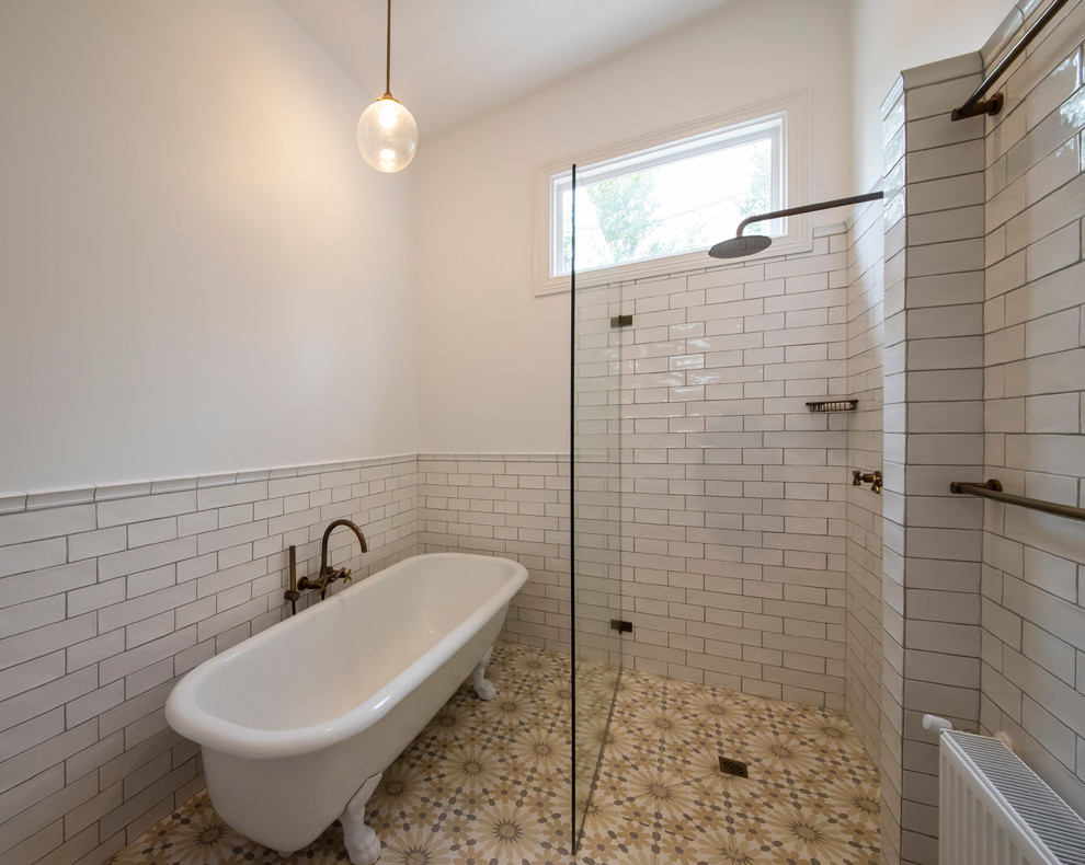 Design ideas for a large mediterranean master bathroom in Melbourne with furniture-like cabinets, medium wood cabinets, a claw-foot tub, a corner shower, a one-piece toilet, white tile, ceramic tile, white walls, cement tiles, an undermount sink, marble benchtops, yellow floor, an open shower, white benchtops, a single vanity and a built-in vanity.