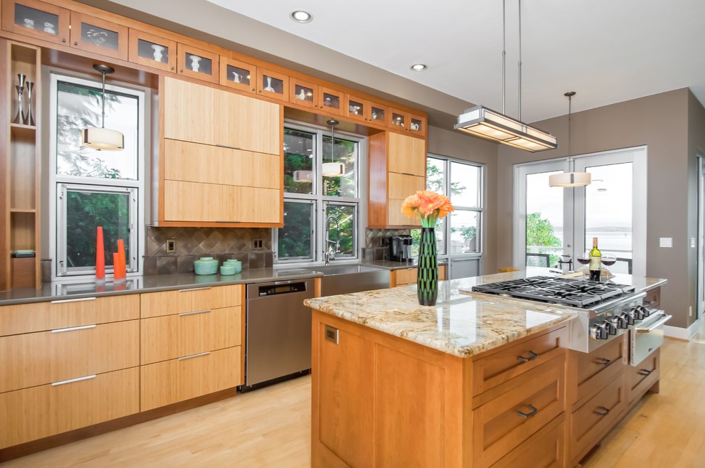Contemporary galley eat-in kitchen in Seattle with a farmhouse sink, flat-panel cabinets, medium wood cabinets, granite benchtops, metallic splashback, ceramic splashback and stainless steel appliances.