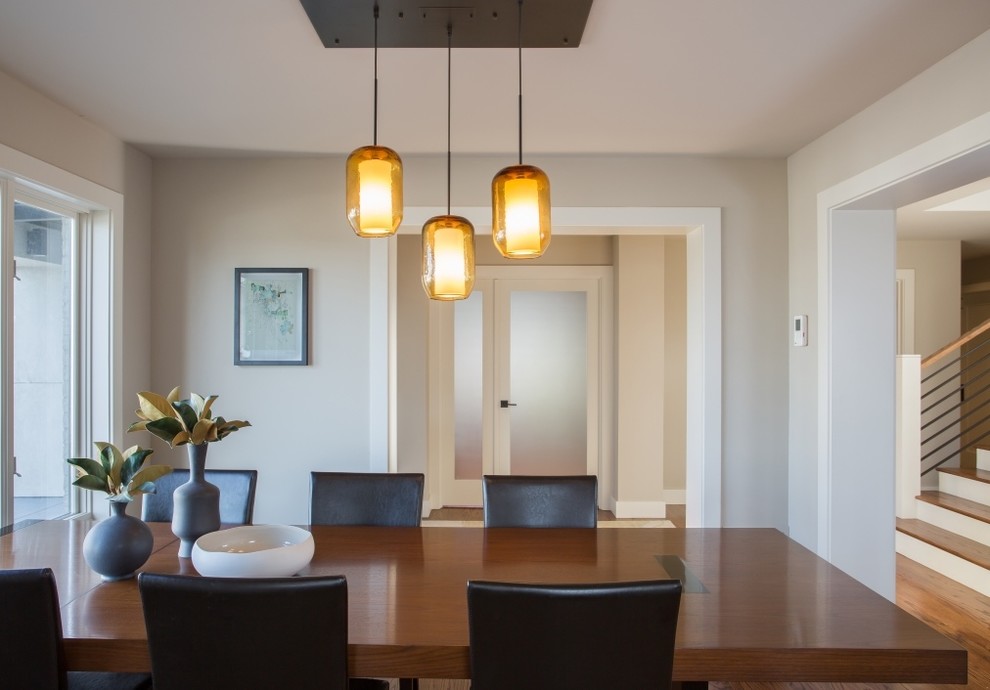 Design ideas for a small contemporary dining room in Seattle with beige walls and medium hardwood floors.