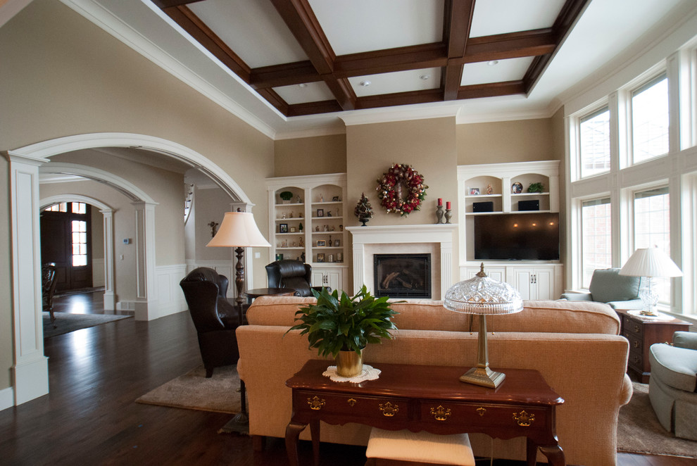 Large traditional formal open concept living room in Other with beige walls, medium hardwood floors, a standard fireplace, a tile fireplace surround and a built-in media wall.