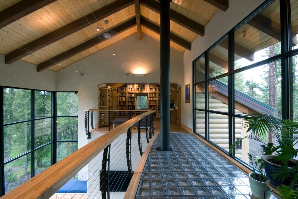 This is an example of a large country family room in New York with a library.