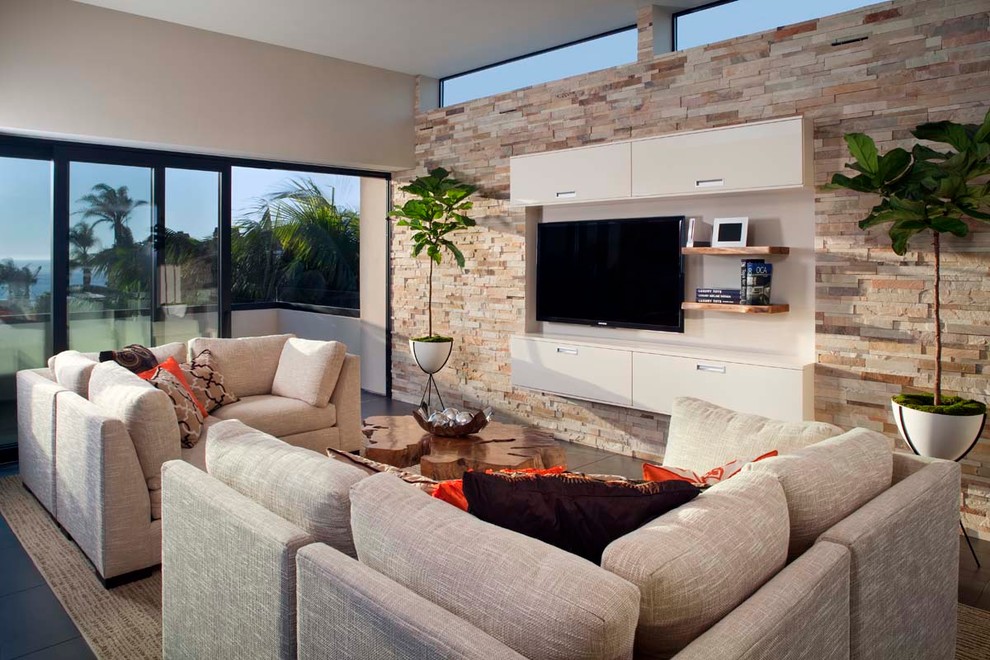 This is an example of a large contemporary open concept living room in San Diego with beige walls and a wall-mounted tv.