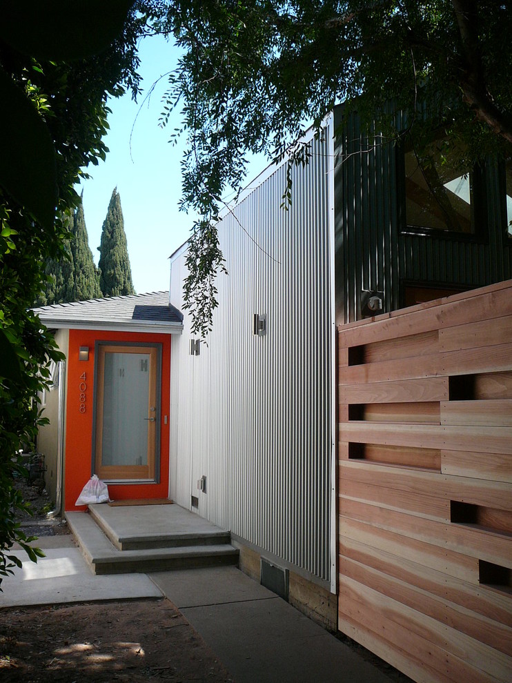 Inspiration for a small industrial one-storey grey exterior in Los Angeles with metal siding and a gable roof.