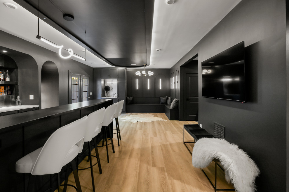Inspiration for a mid-sized modern home bar in DC Metro with an undermount sink, black cabinets, quartz benchtops, black splashback, glass tile splashback, vinyl floors, beige floor and multi-coloured benchtop.