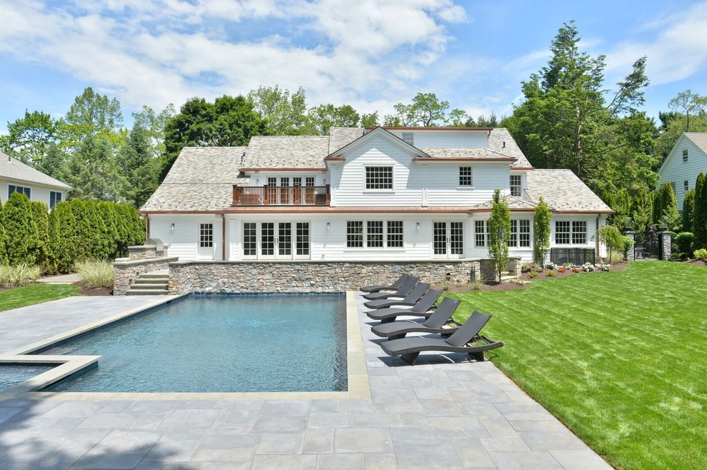 Hot tub - large transitional backyard stone and rectangular lap hot tub idea in New York