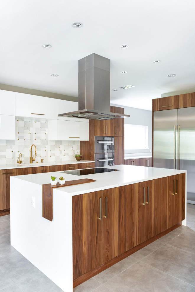 Expansive modern l-shaped eat-in kitchen in Dallas with a single-bowl sink, flat-panel cabinets, medium wood cabinets, quartz benchtops, grey splashback, marble splashback, stainless steel appliances, porcelain floors, grey floor, white benchtop and with island.