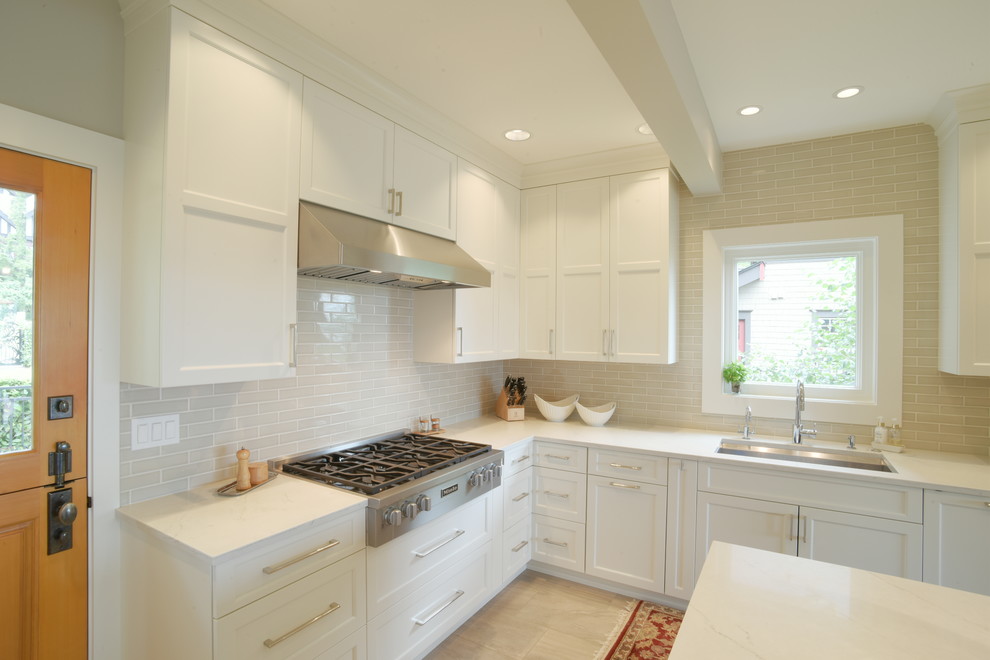 Inspiration for a transitional ceramic tile kitchen remodel in Seattle with shaker cabinets, white cabinets, quartzite countertops, subway tile backsplash, stainless steel appliances, an island and white countertops