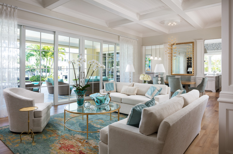 Photo of a mid-sized beach style formal open concept living room in Miami with beige walls, dark hardwood floors, a standard fireplace, a wood fireplace surround, no tv, brown floor, wood and panelled walls.