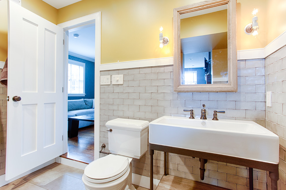Inspiration for a large contemporary kids bathroom in Philadelphia with an undermount sink, an alcove tub, an alcove shower, a one-piece toilet, beige tile, subway tile, yellow walls, furniture-like cabinets and porcelain floors.