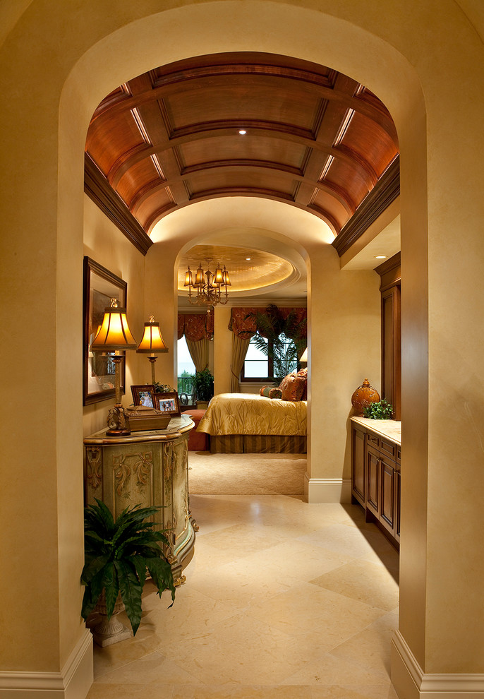 This is an example of a mediterranean hallway in Miami with beige walls and beige floor.