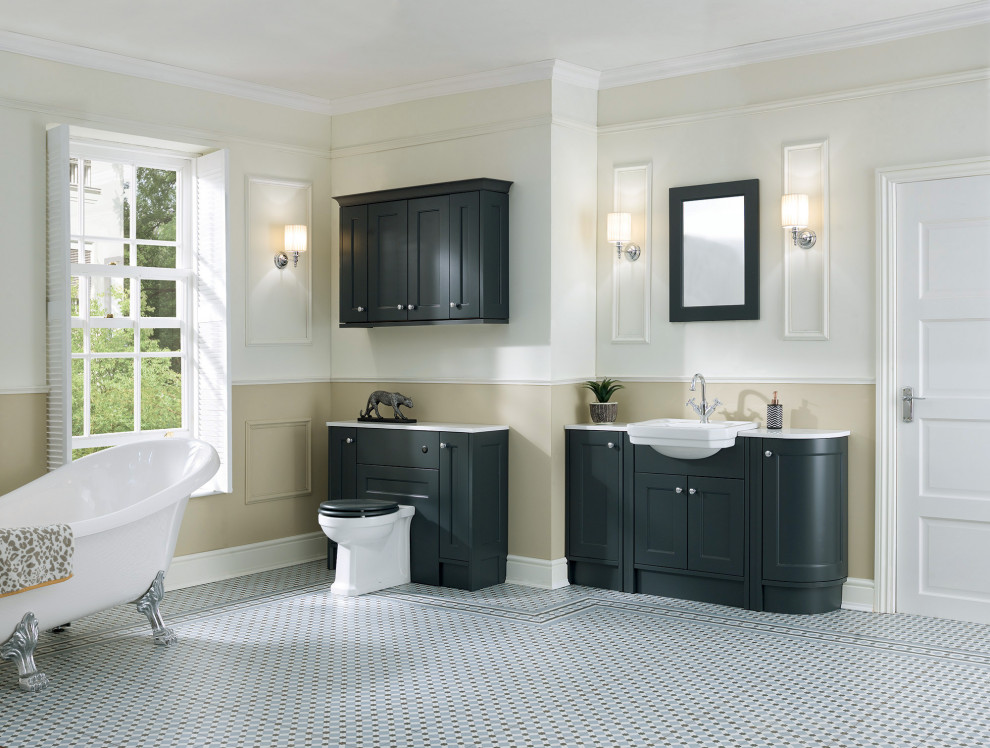 Classic bathroom in West Midlands with recessed-panel cabinets, grey cabinets, a freestanding bath, a one-piece toilet, porcelain flooring, solid surface worktops, white worktops, a single sink and a built in vanity unit.