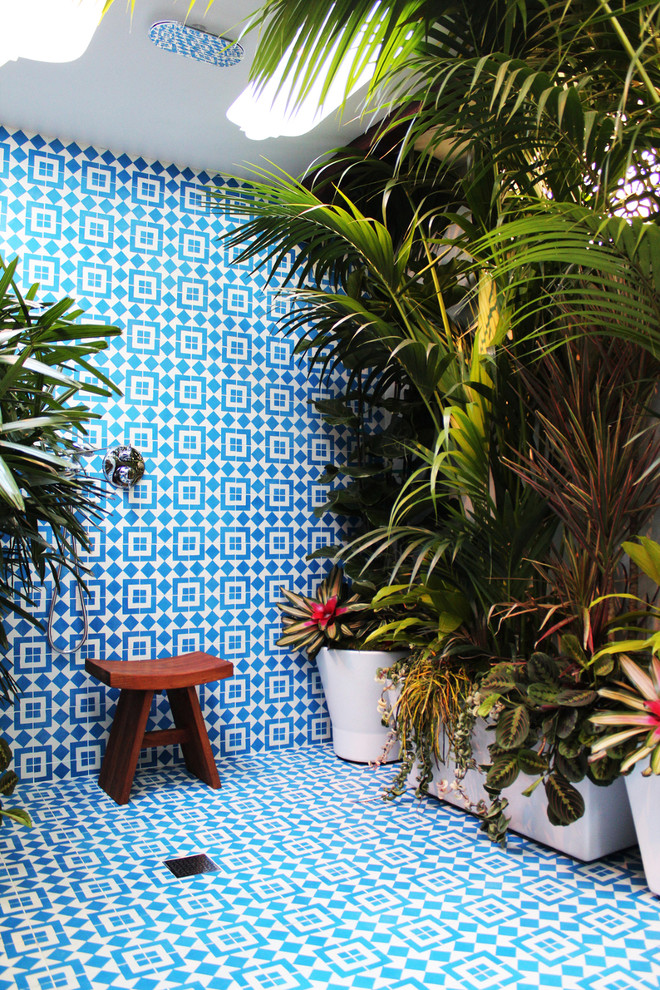 Inspiration for a tropical bathroom in Los Angeles with an open shower, blue tile and an open shower.