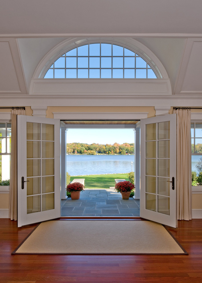 This is an example of a traditional entryway in Boston with a double front door and a glass front door.