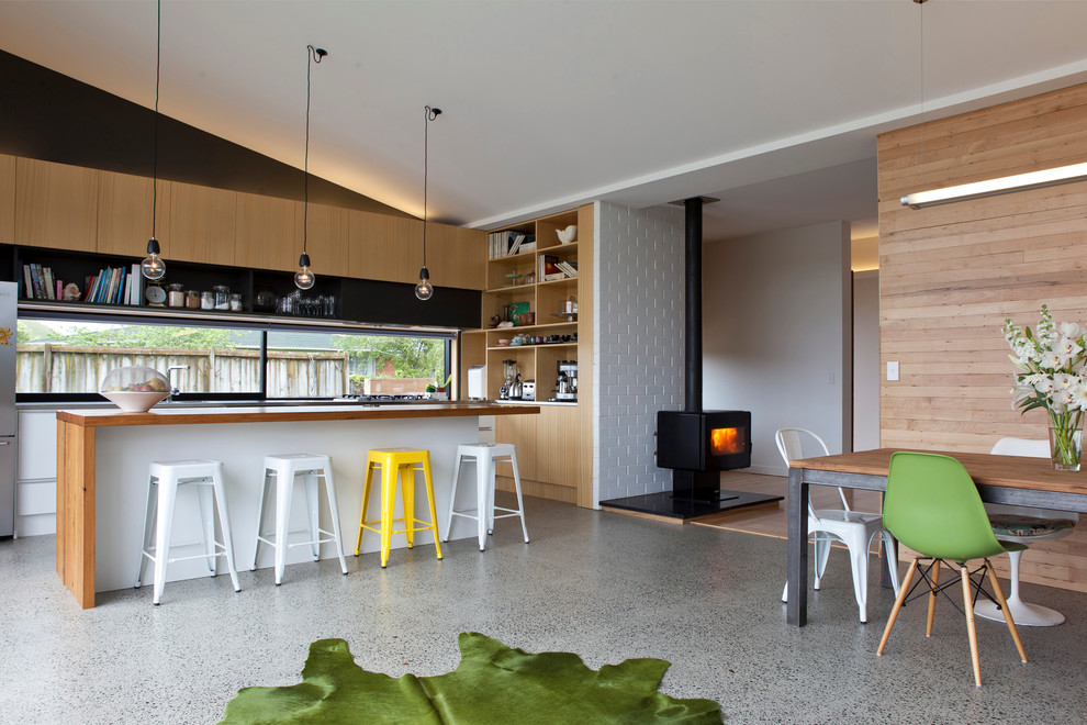 Small contemporary l-shaped eat-in kitchen in Auckland with open cabinets, light wood cabinets, stainless steel appliances and with island.