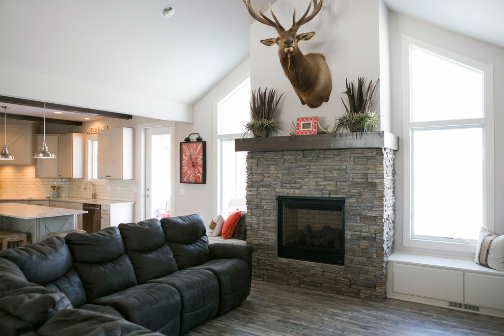 Example of a mid-sized mountain style l-shaped open concept kitchen design with raised-panel cabinets, white cabinets, granite countertops, white backsplash, subway tile backsplash, stainless steel appliances, an island and gray countertops