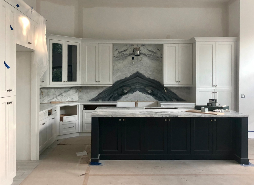 Large transitional l-shaped kitchen in Miami with an undermount sink, shaker cabinets, grey cabinets, quartzite benchtops, grey splashback, stone slab splashback, stainless steel appliances, porcelain floors, with island, grey floor, white benchtop and coffered.