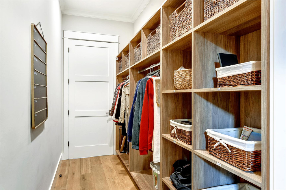 Inspiration for a mid-sized arts and crafts gender-neutral storage and wardrobe in San Francisco with open cabinets, medium wood cabinets, medium hardwood floors and brown floor.
