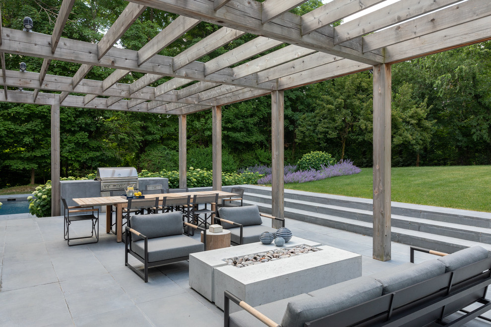 Inspiration for a country backyard patio in New York with a pergola.