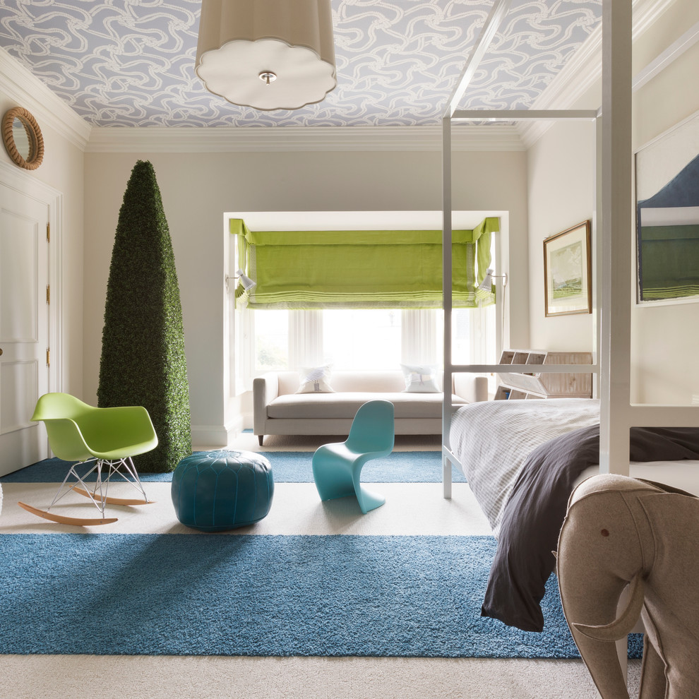 This is an example of a contemporary gender-neutral kids' bedroom in Los Angeles with beige walls and carpet.