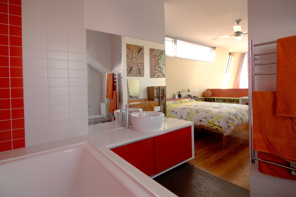 Design ideas for a small contemporary master bedroom in Other with red walls and medium hardwood floors.