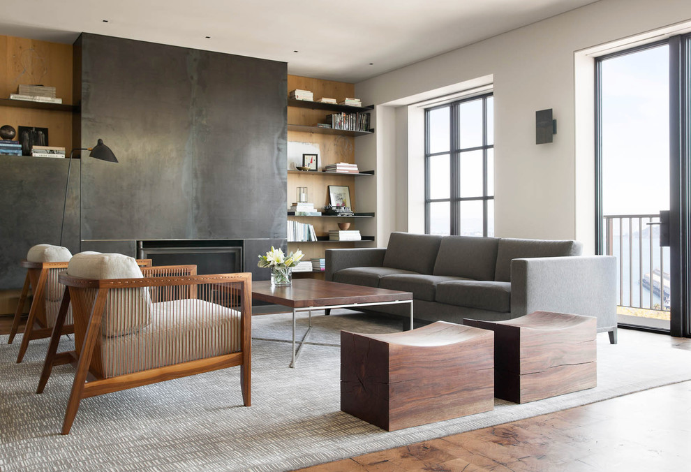 Inspiration for a mid-sized contemporary formal enclosed living room in San Francisco with white walls, a standard fireplace, a metal fireplace surround and a concealed tv.