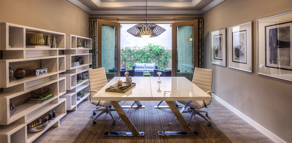 Mid-sized contemporary study room in Phoenix with beige walls, light hardwood floors and a freestanding desk.