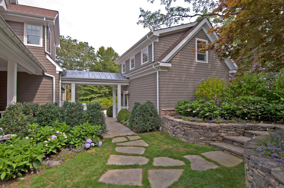 Photo of a traditional backyard garden in New York with natural stone pavers.