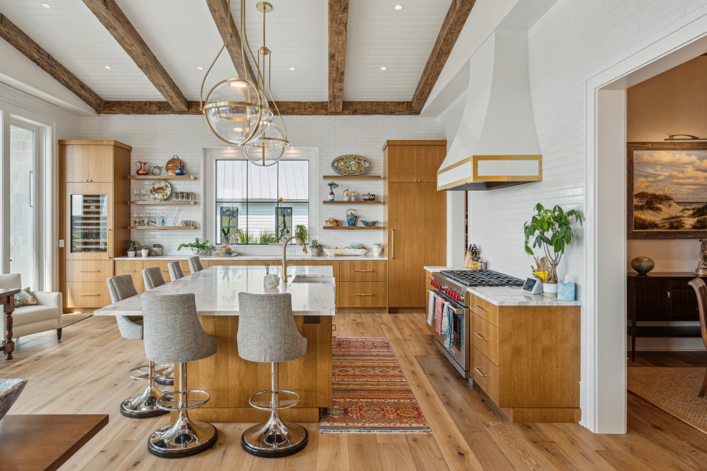 Trendy l-shaped medium tone wood floor, brown floor, exposed beam, shiplap ceiling and vaulted ceiling kitchen photo in Charleston with a farmhouse sink, flat-panel cabinets, medium tone wood cabinets, white backsplash, subway tile backsplash, stainless steel appliances, an island and white countertops