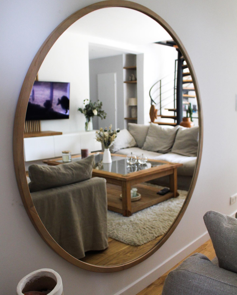 Design ideas for a traditional open plan living room in Bordeaux with white walls and light hardwood flooring.