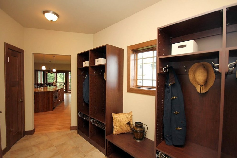 Example of a mid-sized transitional ceramic tile mudroom design with beige walls