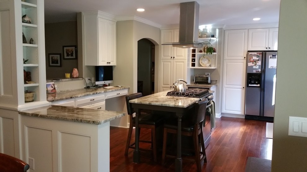 Mid-sized transitional u-shaped medium tone wood floor and brown floor kitchen pantry photo with raised-panel cabinets, white cabinets, granite countertops, stainless steel appliances, an island, gray countertops, blue backsplash and subway tile backsplash