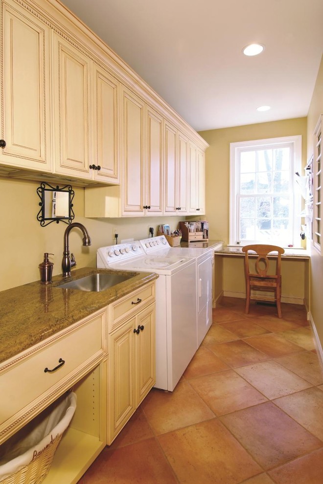Design ideas for a traditional laundry room in DC Metro with white cabinets and pink floor.