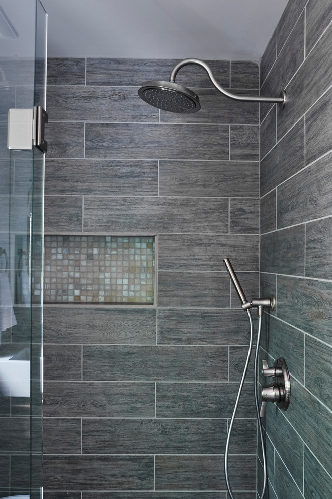 Design ideas for a large modern 3/4 bathroom in Richmond with raised-panel cabinets, medium wood cabinets, an alcove shower, a one-piece toilet, gray tile, porcelain tile, white walls, porcelain floors, a trough sink and concrete benchtops.