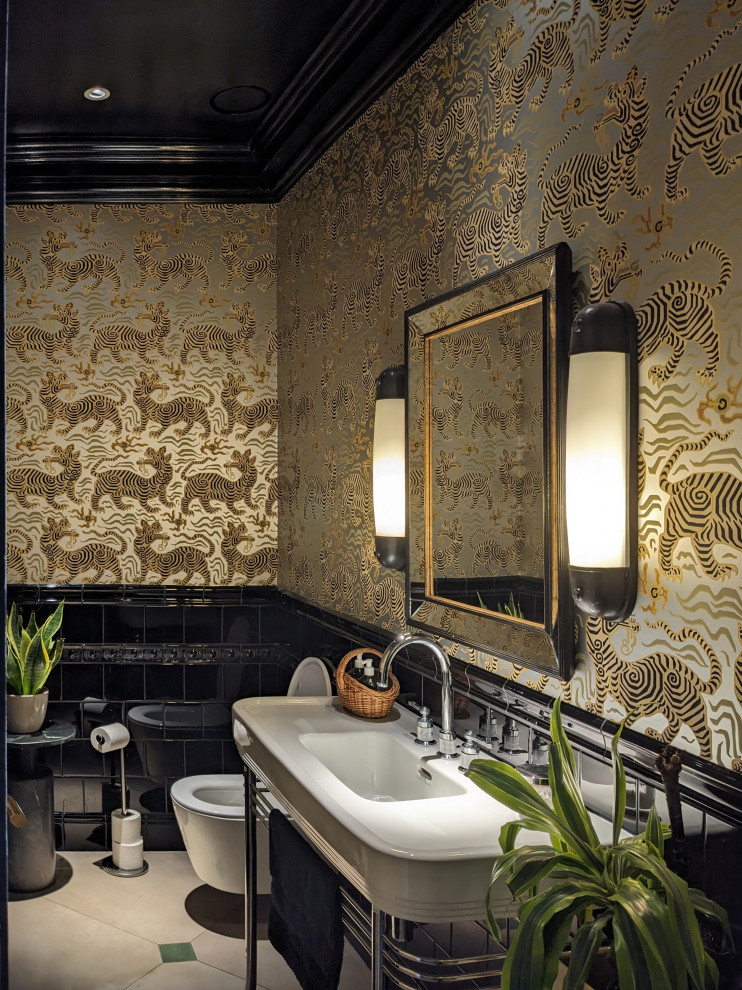 Photo of a world-inspired bathroom in London with a console sink, beige floors, a single sink and wallpapered walls.