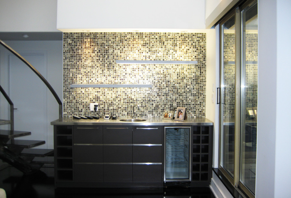 This is an example of a small contemporary single-wall wet bar in Vancouver with an integrated sink, flat-panel cabinets, dark wood cabinets, stainless steel benchtops, multi-coloured splashback, mosaic tile splashback and dark hardwood floors.