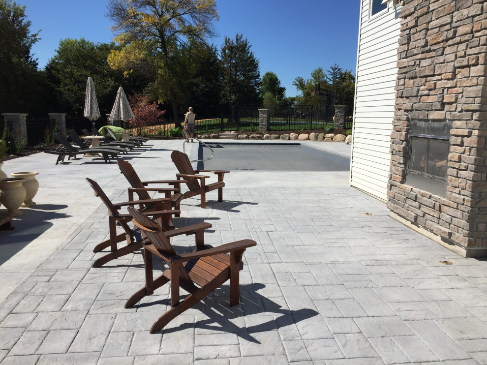 Design ideas for a large country backyard patio in Minneapolis with concrete pavers.