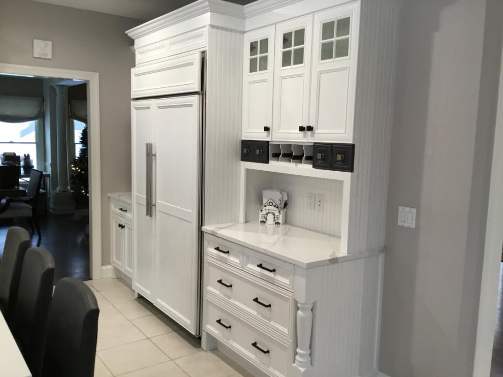 A Transitional Kitchen with a gorgeous Herringbone marble backsplash