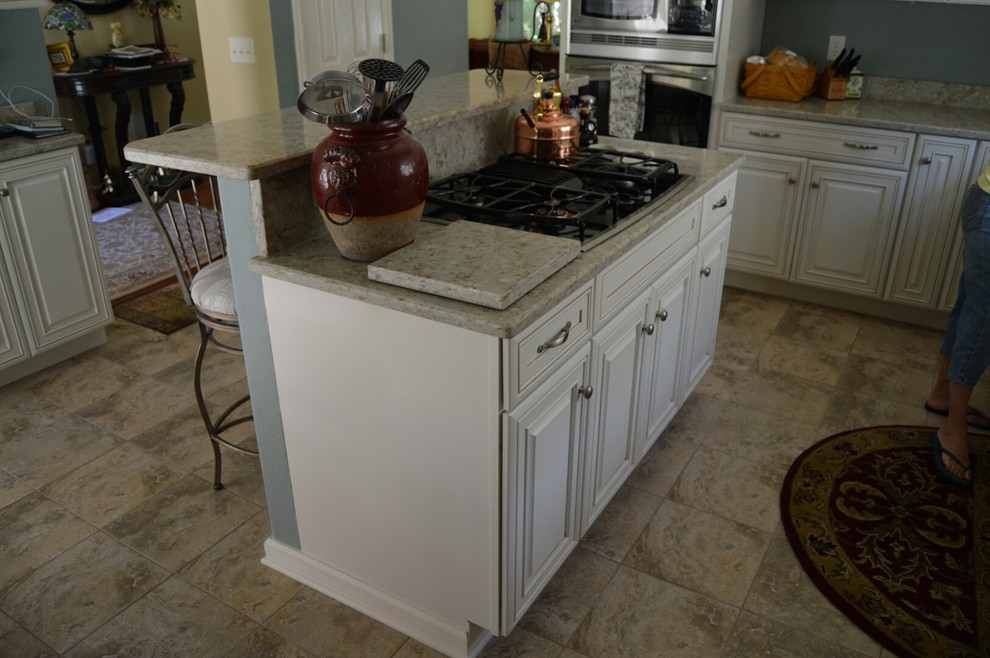 Inspiration for a mid-sized traditional l-shaped eat-in kitchen in Other with with island, raised-panel cabinets, beige cabinets, quartz benchtops, stainless steel appliances, an undermount sink and ceramic floors.