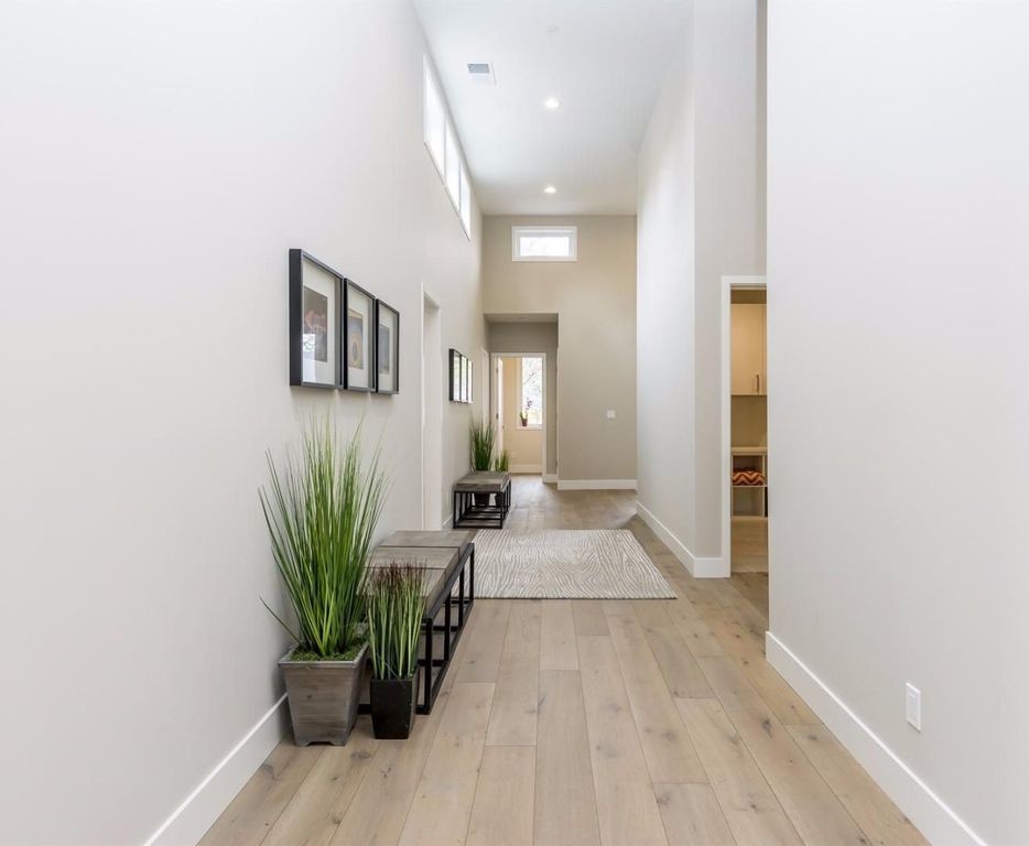 Hallway - mid-sized transitional light wood floor and brown floor hallway idea in San Francisco with gray walls