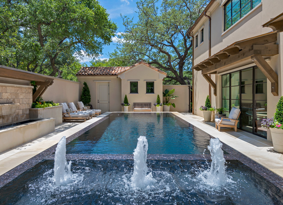 Design ideas for a large mediterranean rectangular pool in Dallas with a hot tub.