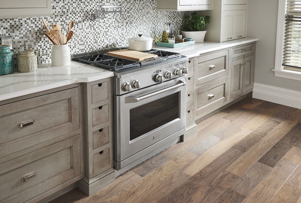 Kitchen - mid-sized transitional single-wall dark wood floor and brown floor kitchen idea in Cincinnati with stainless steel appliances, recessed-panel cabinets, dark wood cabinets, marble countertops, multicolored backsplash, mosaic tile backsplash and white countertops