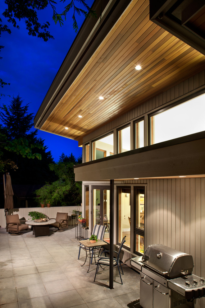 Design ideas for a contemporary two-storey grey exterior in Vancouver with wood siding.