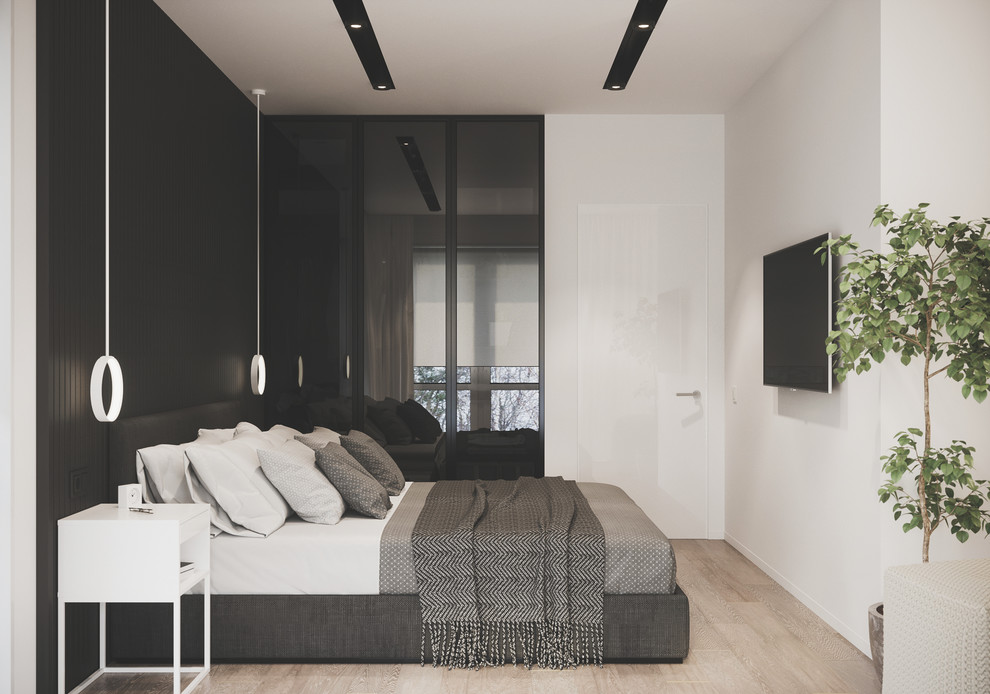 This is an example of a mid-sized contemporary master bedroom in Valencia with black walls, light hardwood floors and beige floor.