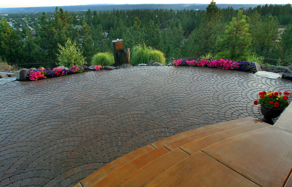 Photo of a large contemporary backyard garden in Seattle with natural stone pavers.