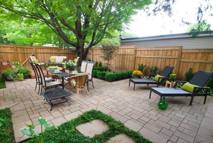 This is an example of a large traditional backyard patio in Montreal with a fire feature, brick pavers and no cover.
