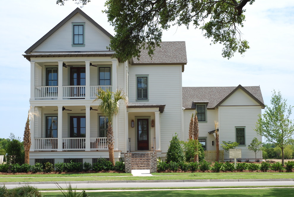 This is an example of a traditional exterior in Charleston with wood siding.