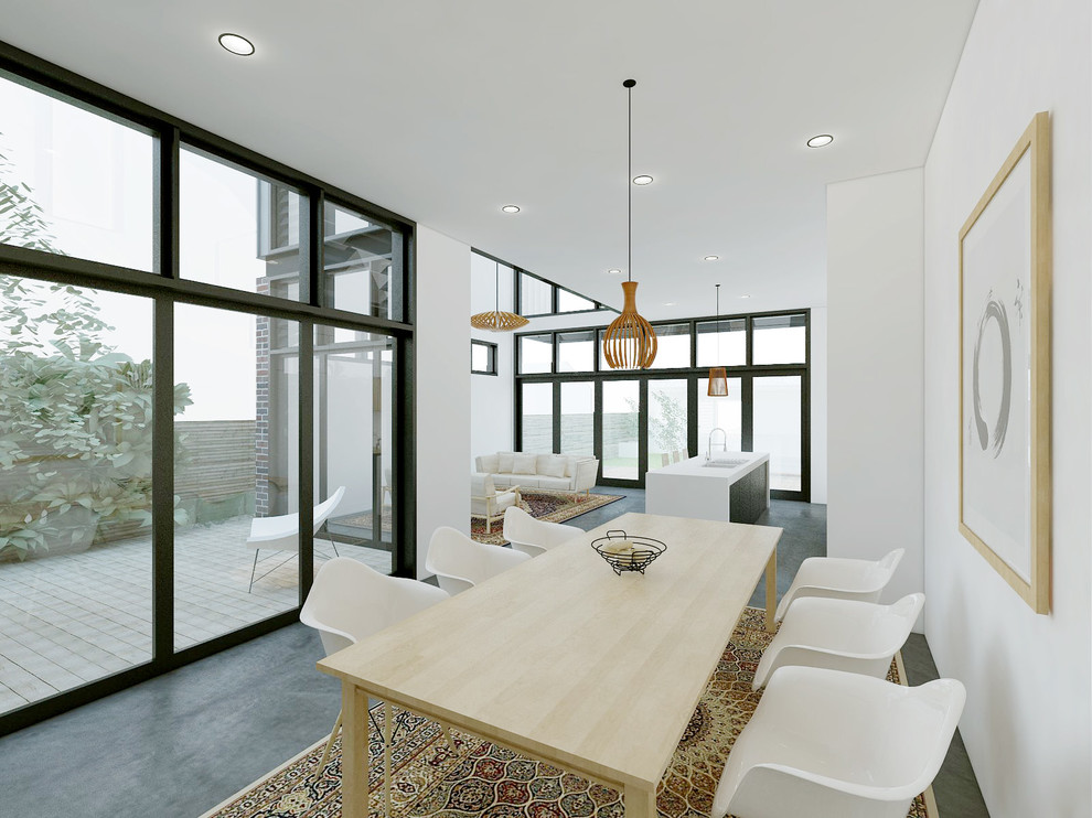 Idées déco pour une salle à manger ouverte sur la cuisine contemporaine de taille moyenne avec un mur blanc et sol en béton ciré.