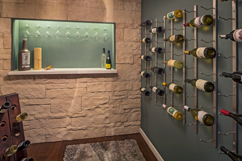 Wine cellar - contemporary dark wood floor wine cellar idea in San Francisco with gray walls and display racks